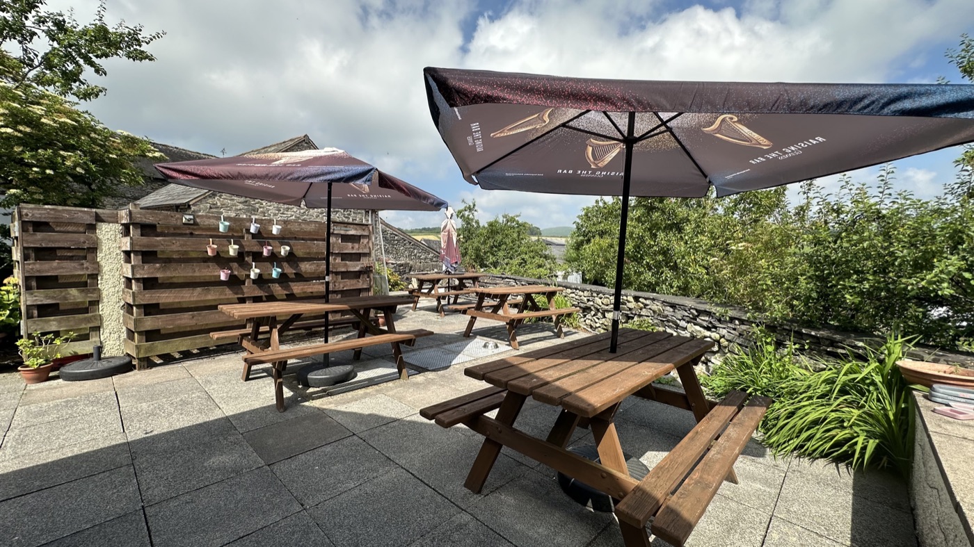 The beer garden, with picnic tables and views across the valley