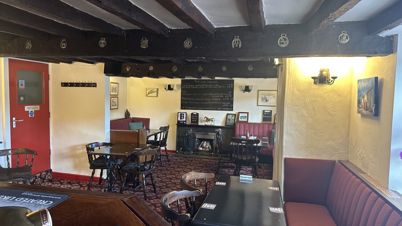 The beamed dining room with its open fire and horse brasses